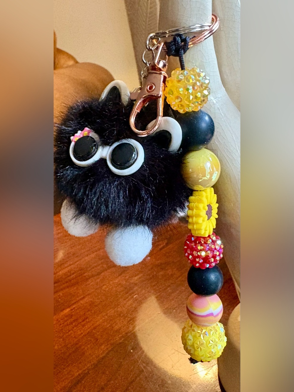 Yellow and black beaded sunflower keychain bag charm with fluffy cat charm